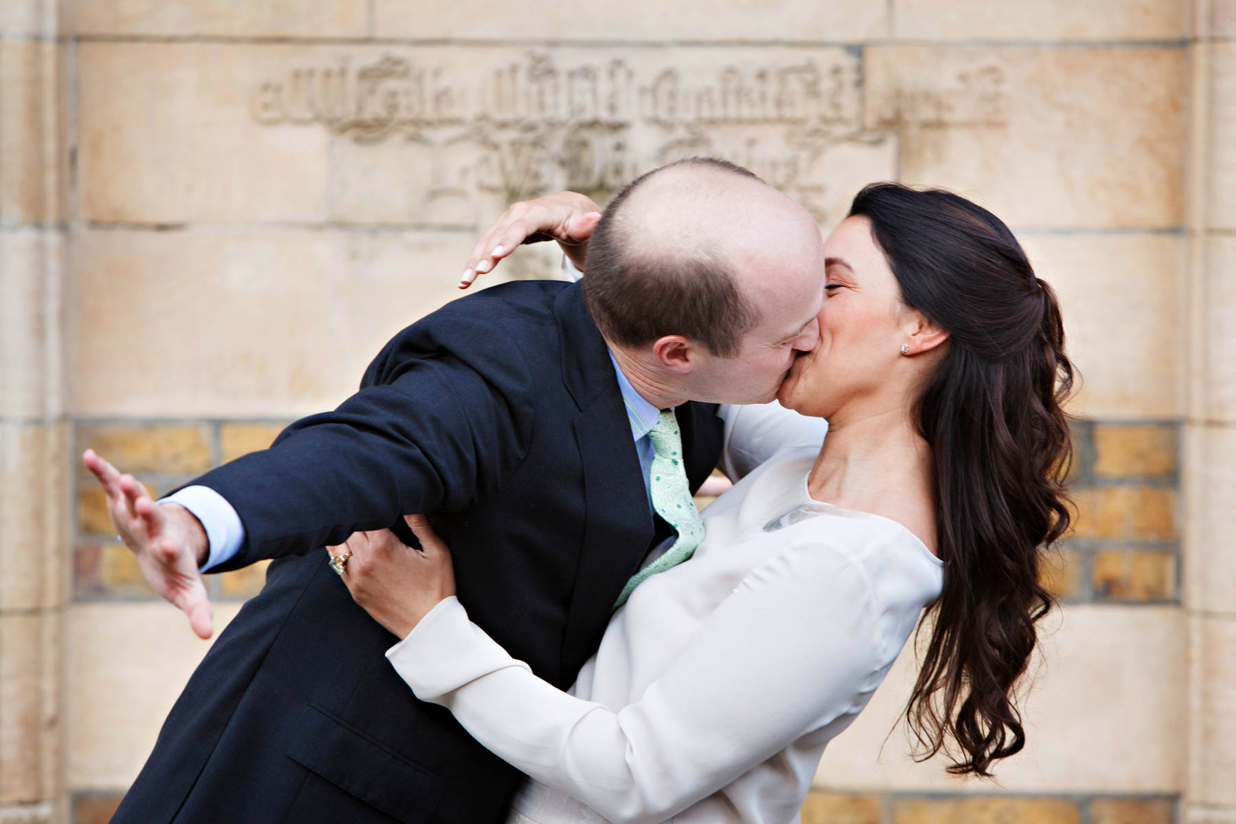A bride and groom have fun kissing and fooling around during their relaxed informal wedding portraits, ahead of getting married at Chelsea Old Town Hall later on in the day.