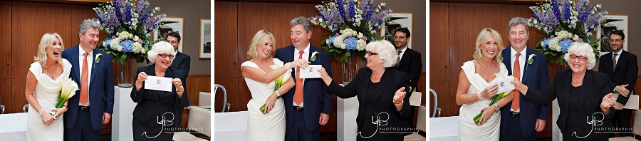 Photography of the bride and groom receiving their marriage certificate from a Chelsea registrar at The Bluebird on Kings Road. 