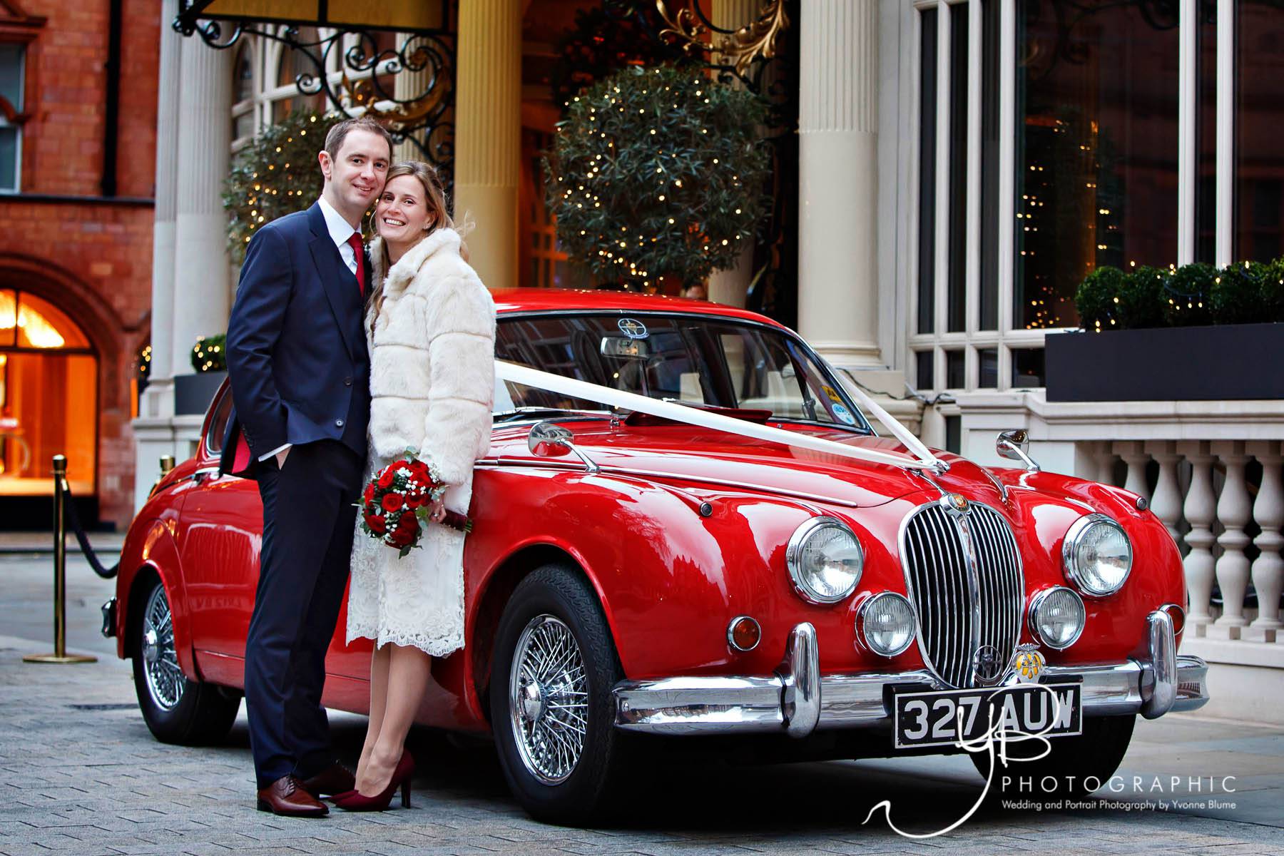 christmas wedding portrait with red vintage Jaguar MK2 wedding car