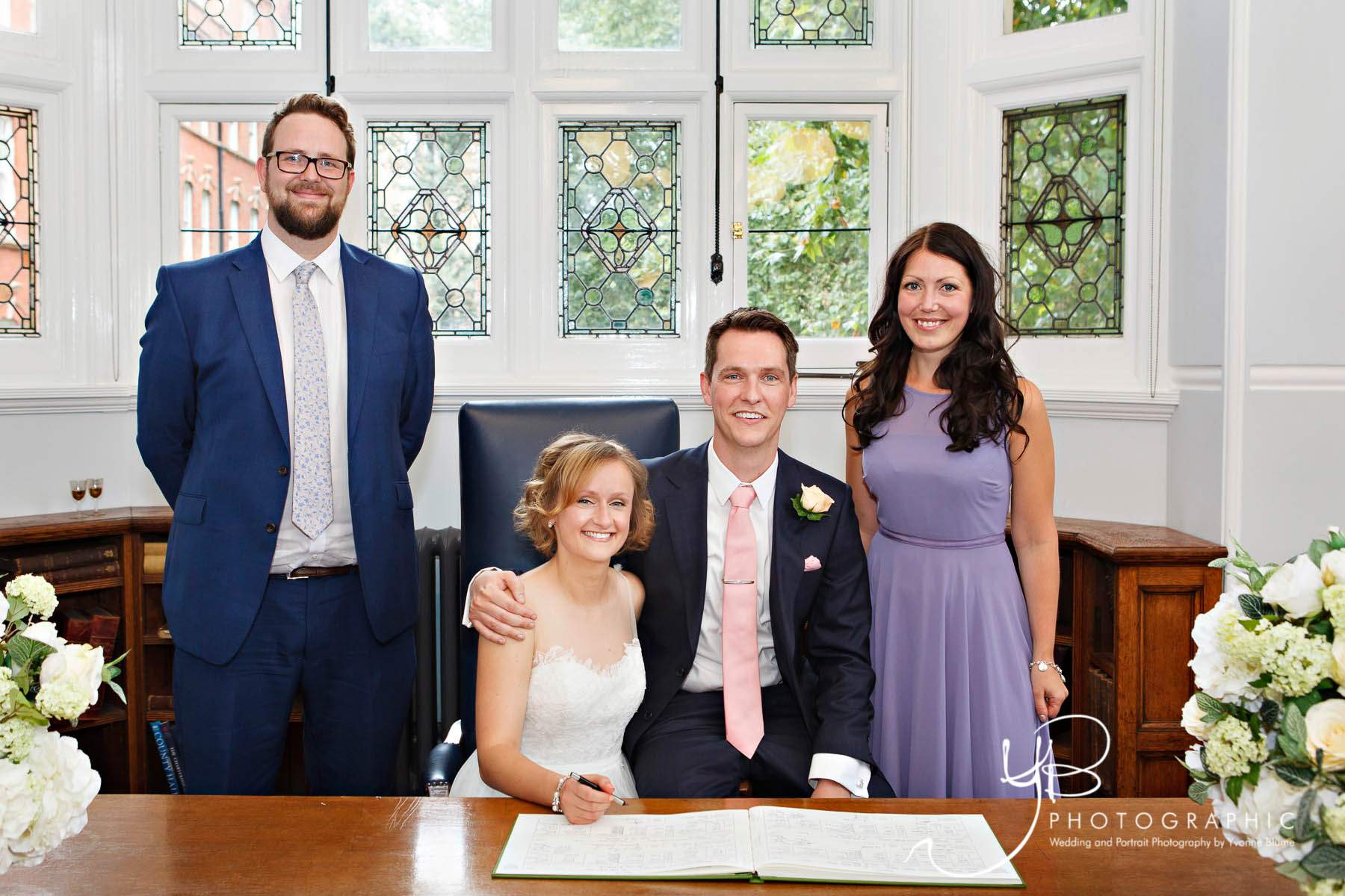 The bride and groom pose with their witness after signing the register