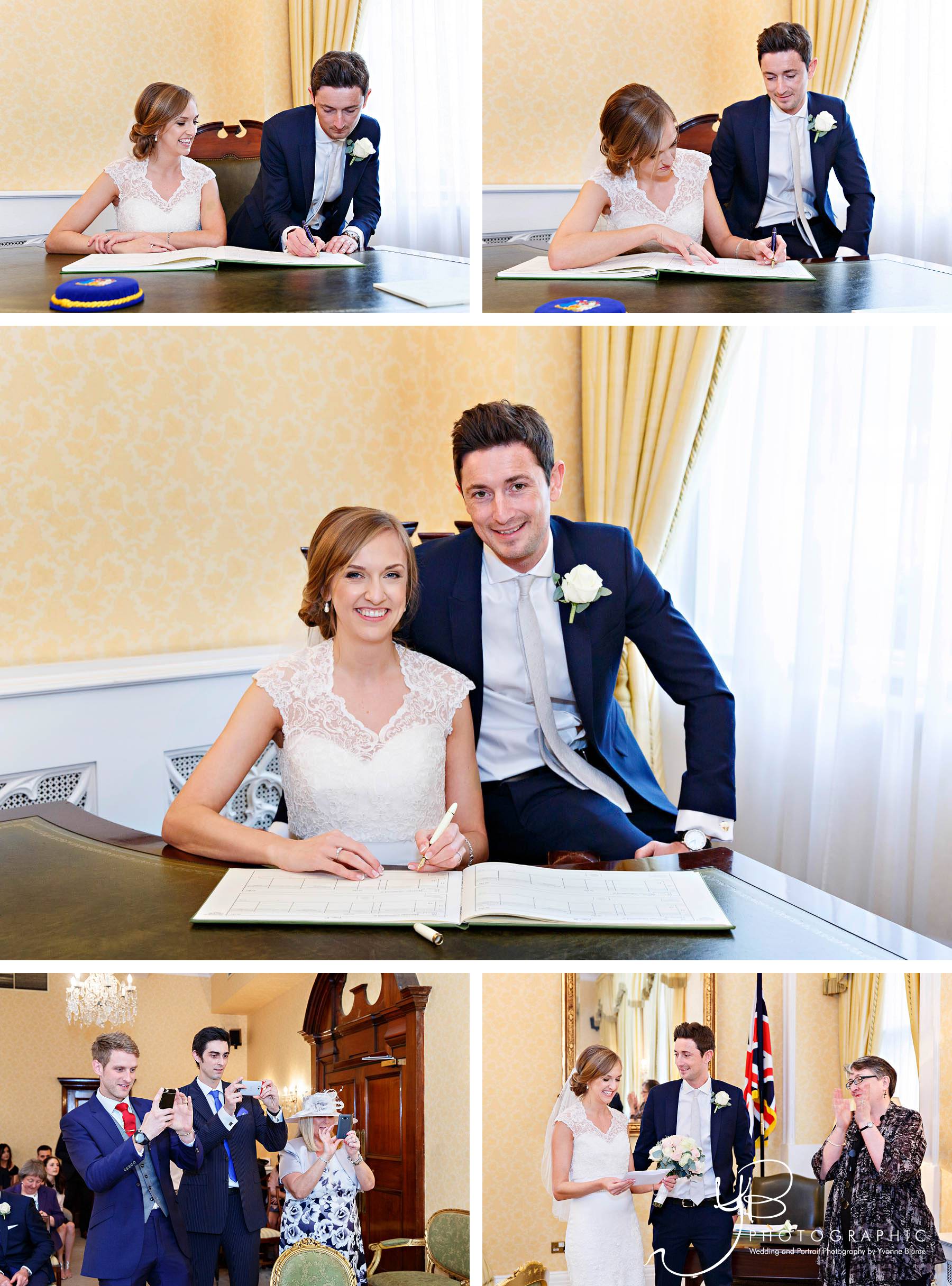 The bride and groom sign the register and receive their wedding certificate in the Brydon Room at Chelsea Register Office