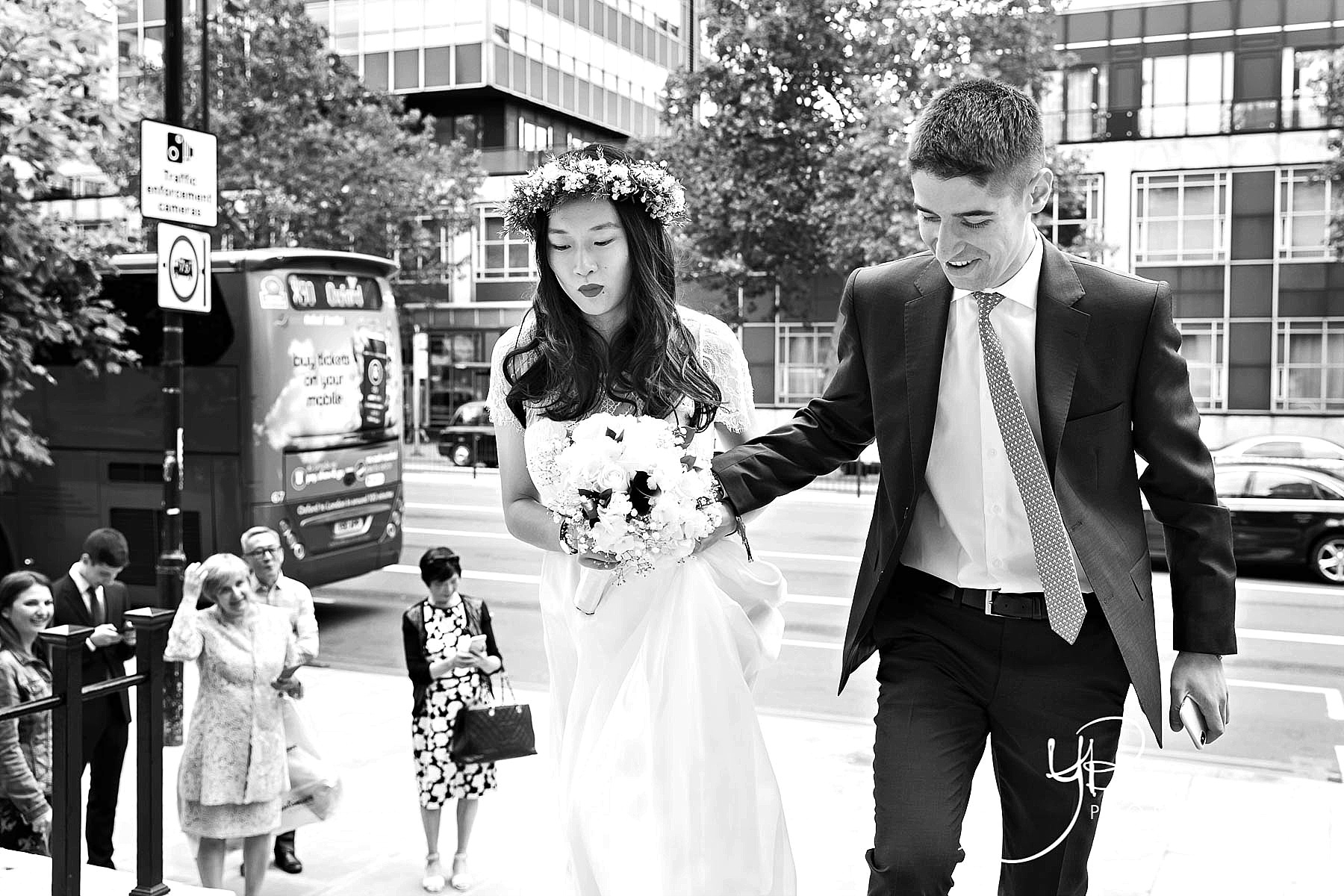 A bride and groom arrive for their Soho Room civil marriage ceremony, with the bride wearing a flower crown.