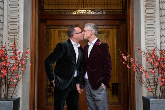 Grooms kiss after their wedding ceremony at Marylebone Old Town Hall.