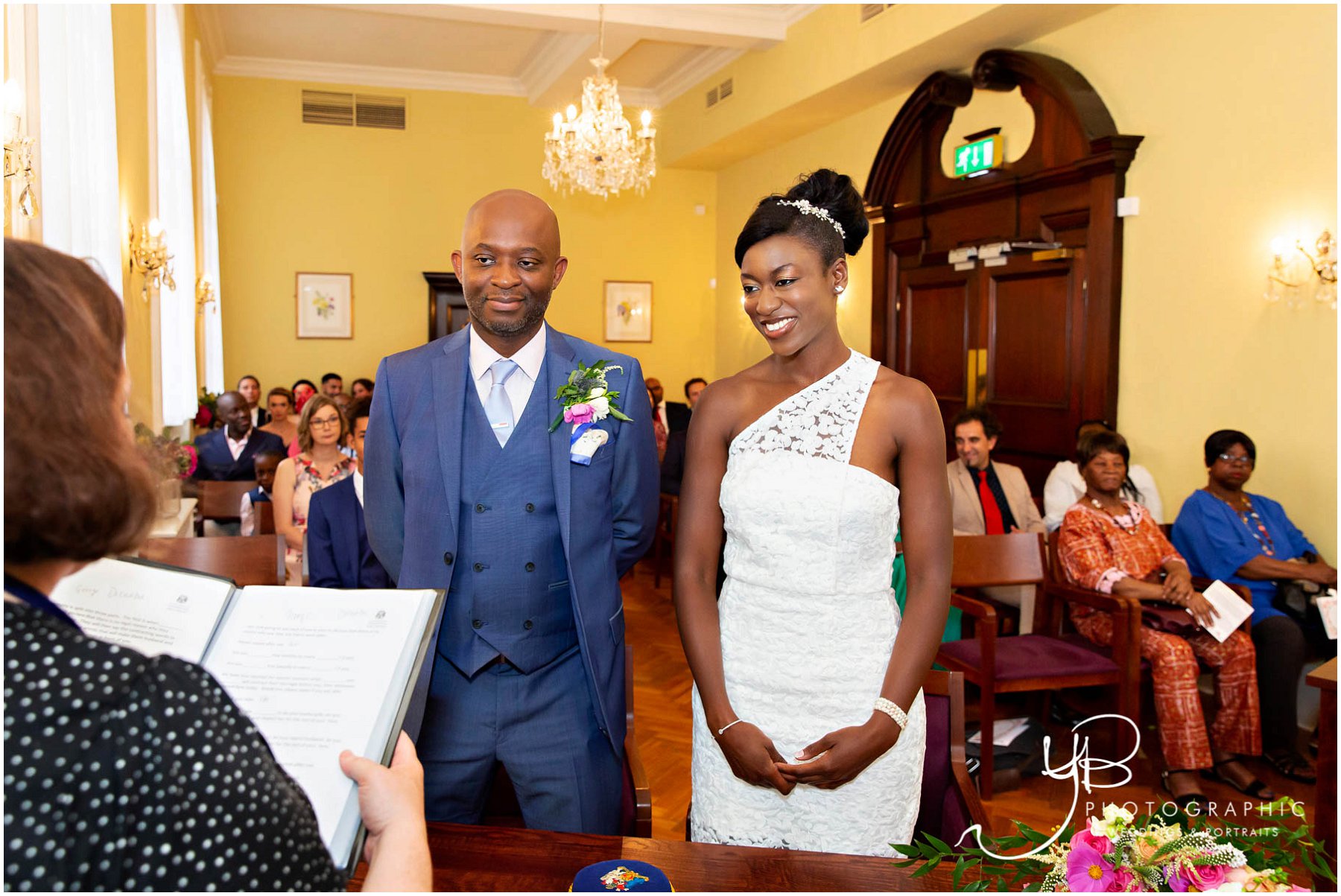 The bride and groom get ready to exchange their marriage vows in the Brydon Room at Chelsea Register Office | ybphotographic