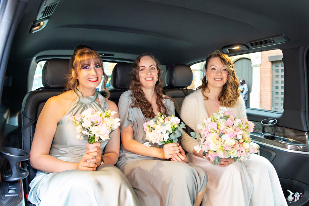 The bride arrives at Chelsea Old Town Hall with her bridesmaids in a black London taxi