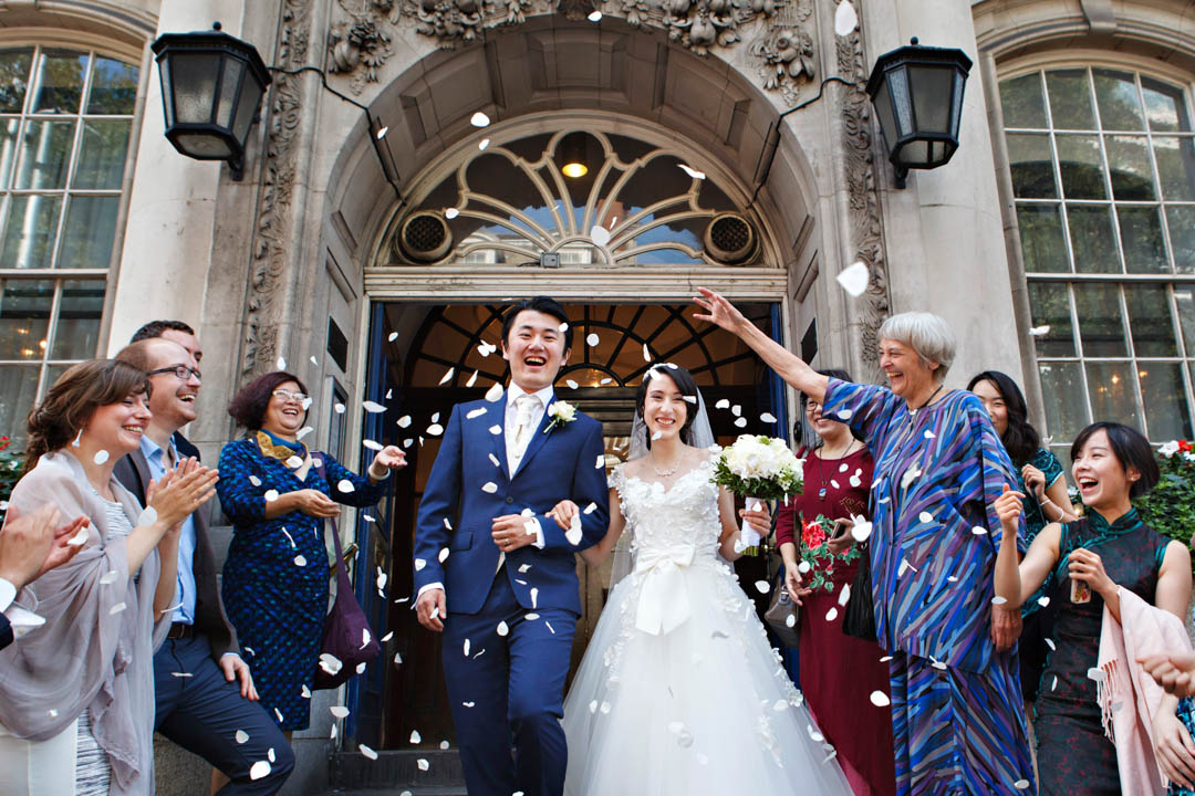 Newlyweds emerge onto the Kings Road steps of Chelsea Old Town Hall after their Brydon Room wedding ceremony.