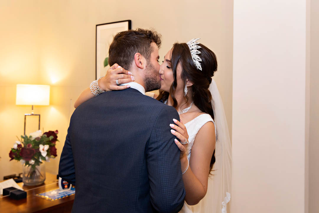 A bride passionately kisses her groom in the Harrington Room at Chelsea Old Town Hall as they are declared husband and wife