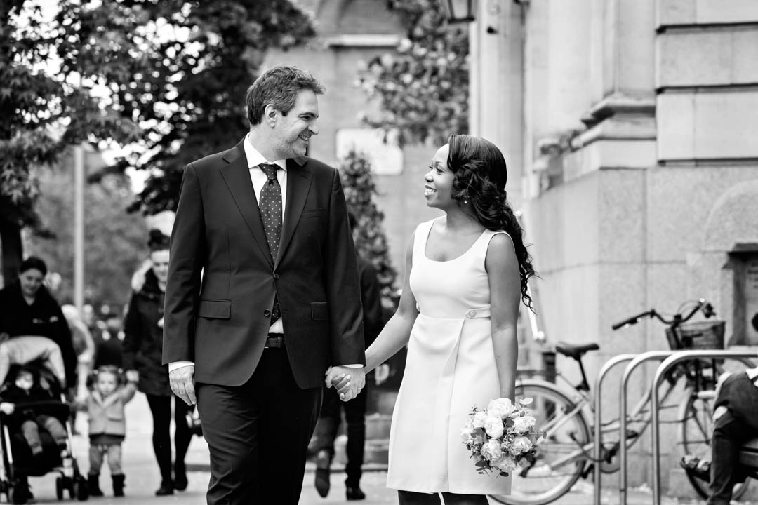 Bride and groom walk along the King's Road after their civil wedding ceremony in the Harrington Room at Chelsea Old Town Hall