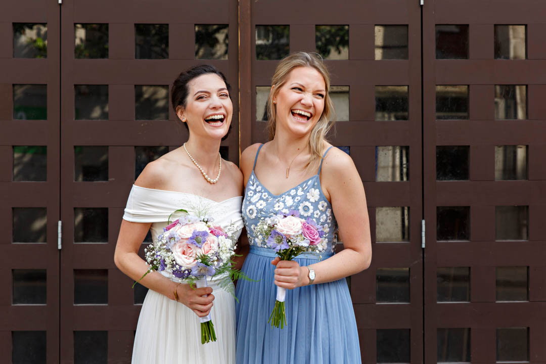 Two women holding bouquets.