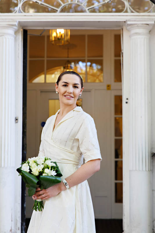 A bride poses for a bridal portraits before going into the register office to get married.