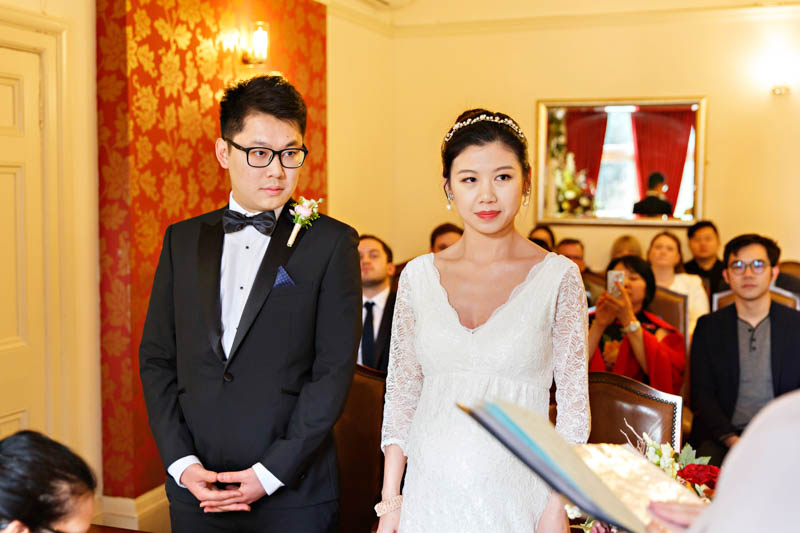 A bride and groom pay close attention the registrar at the start of their civil wedding ceremony.