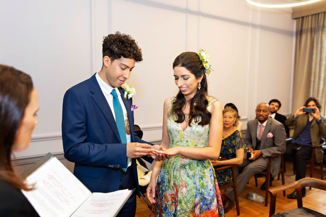 A bride and groom exchange rings in the Knightsbridge Room