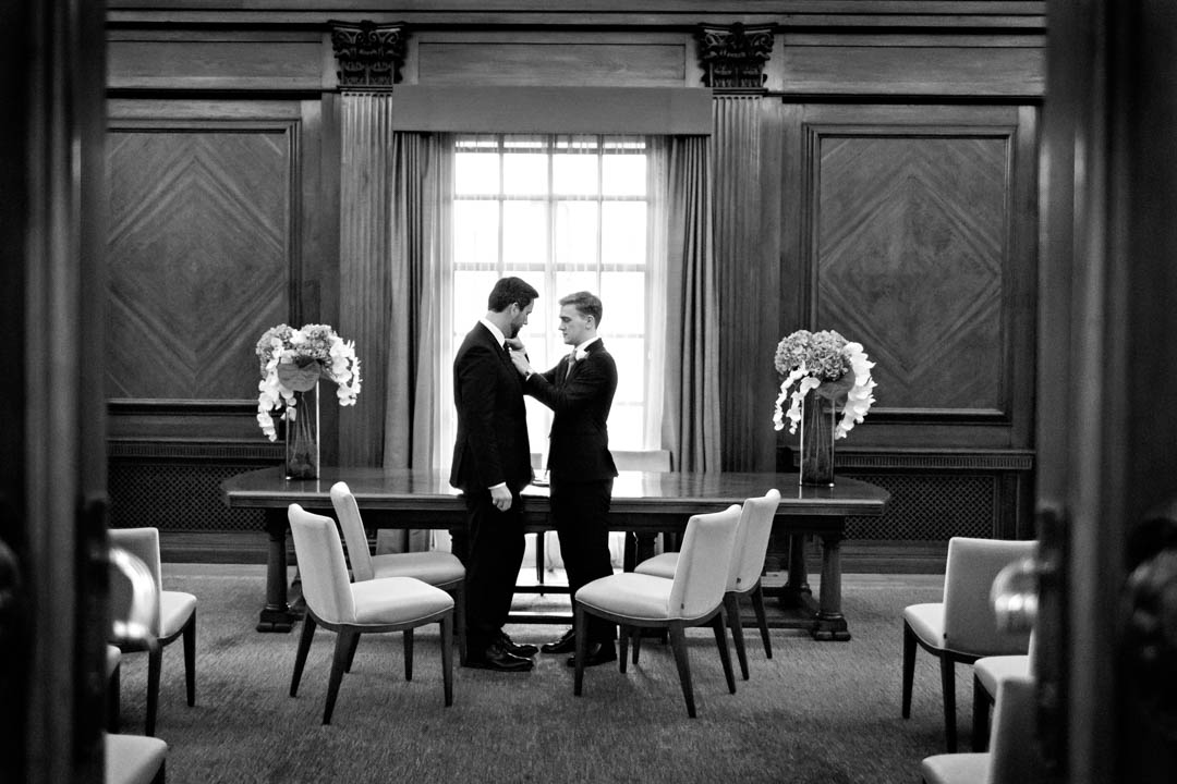 Two grooms share a private moment ahead of their civil wedding ceremony.