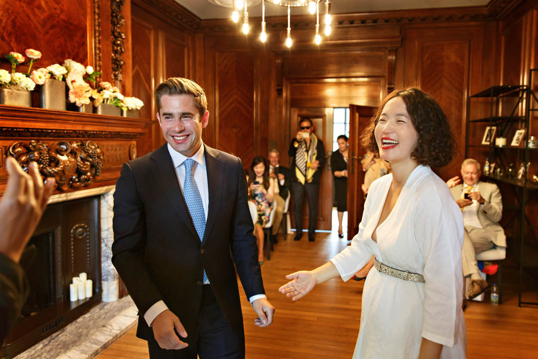 The groom and bride look happy and smiley as they reach the end of their Marylebone room wedding.