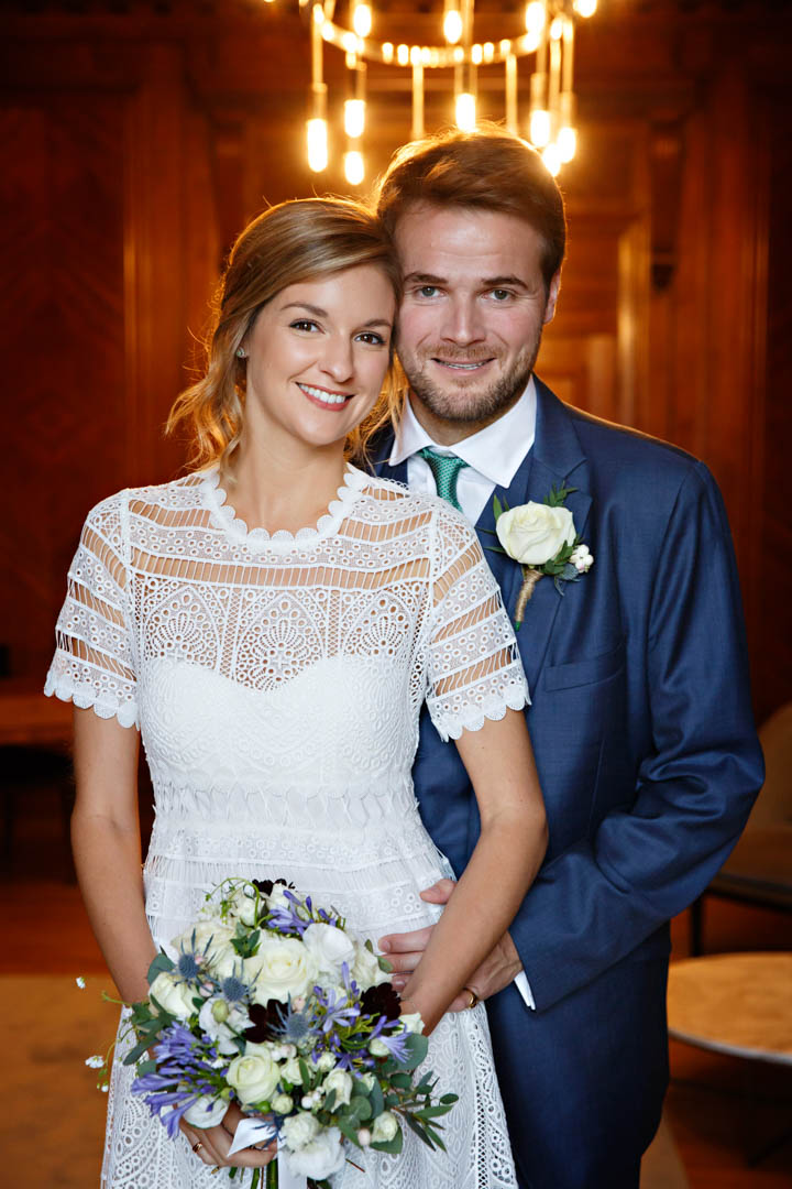 A bride and groom use the gorgeous wood panelling of the Marylebone room as the backdrop for their wedding portrait.