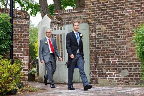 The groom wearing tails and his father arrive for his civil wedding at Morden Park House.