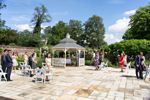 The groom waits for his bride to arrive in the gazebo at Morden Park House.