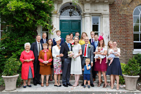 Big family group photograph outside Morden Park House at the end of the couple's wedding ceremony.