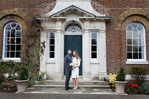 Bride and Groom pose for wedding portrait after their register office wedding at Morden Park House.