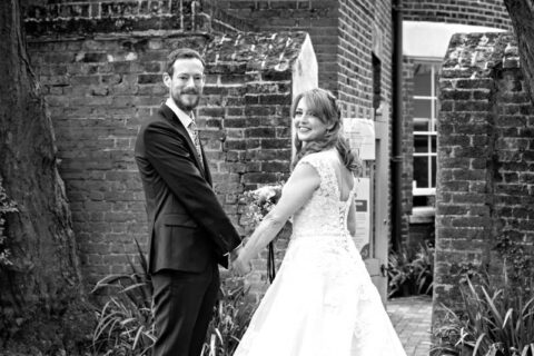 Newlyweds pose for their wedding portraits outside Merton Register Office in Morden Park.