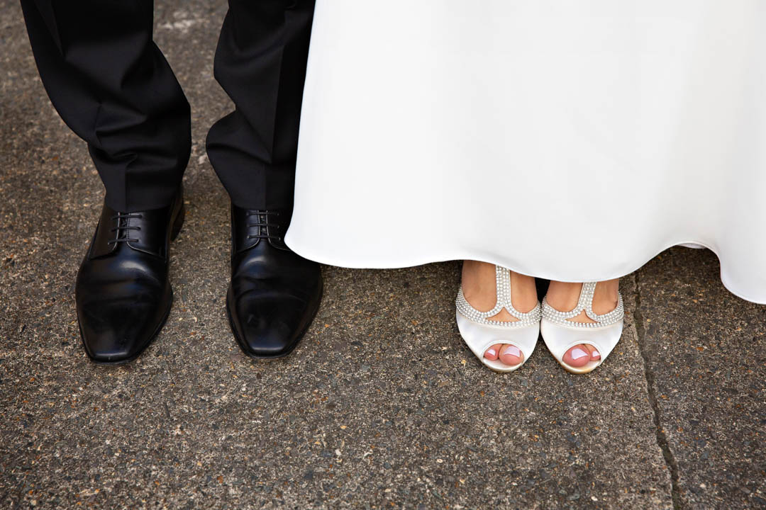 A close-up wedding classic photo: the bride and groom's feet, beautifully groomed for their special day.