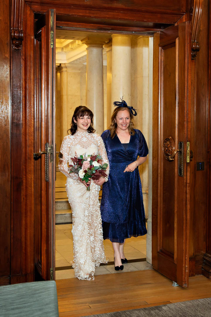 The bride and mother of the bride walk into the Westminster Room, to walk down the aisle together.