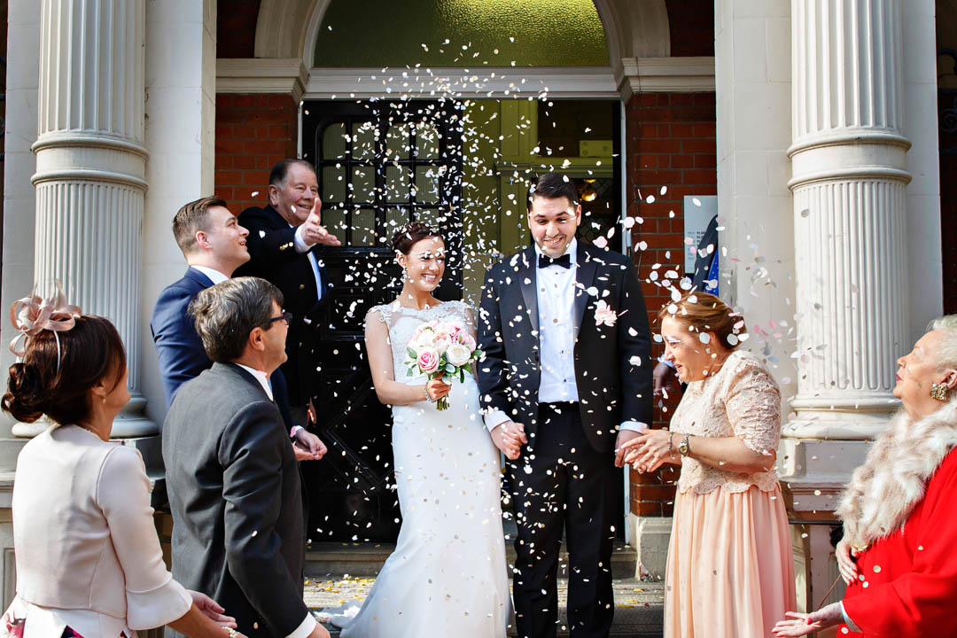 The newlyweds exit Mayfair Library into a flurry of confetti thrown by their guests, after getting married in the Marylebone Room.